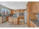 Well-equipped kitchen with stainless appliances, an island, and granite countertops at 15972 E Tall Timber Ln, Parker, CO 80134