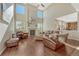 Bright living room with a fireplace, tall ceilings, and lots of natural light at 15972 E Tall Timber Ln, Parker, CO 80134