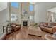 Elegant living room with a cozy fireplace, stylish furniture, and an open design at 15972 E Tall Timber Ln, Parker, CO 80134