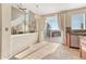 Bright living room with fireplace, tile flooring, chandelier, and access to outdoor deck at 15972 E Tall Timber Ln, Parker, CO 80134