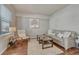 Cozy living room features neutral decor and wood floors at 15972 E Tall Timber Ln, Parker, CO 80134