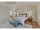 Vaulted main bedroom featuring a ceiling fan, ensuite bathroom, and neutral walls at 15972 E Tall Timber Ln, Parker, CO 80134