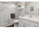 Bright bathroom with a shower, a toilet, and a vanity with a white countertop at 4976 S Nelson St # A, Littleton, CO 80127