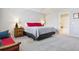 Spacious bedroom featuring a queen-sized bed, side tables, and easy access to the bathroom at 4976 S Nelson St # A, Littleton, CO 80127