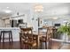 Well-lit dining room adjacent to kitchen area featuring dark hardwood flooring at 4976 S Nelson St # A, Littleton, CO 80127