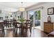 Elegant dining room with a stylish light fixture and sliding glass doors that lead to the outside deck at 4976 S Nelson St # A, Littleton, CO 80127