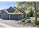 Inviting front exterior showcasing a well-maintained lawn, mature trees, and an attached two-car garage at 4976 S Nelson St # A, Littleton, CO 80127