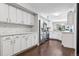 Updated kitchen with stainless steel appliances, white cabinetry, and a tiled backsplash for a clean, modern look at 4976 S Nelson St # A, Littleton, CO 80127