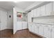 Functional laundry area with white cabinets, washer, and dryer at 4976 S Nelson St # A, Littleton, CO 80127