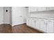 Bright laundry room featuring white cabinets, countertop space, and tile backsplash at 4976 S Nelson St # A, Littleton, CO 80127