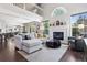 Open concept living room with fireplace, large windows, and comfortable sectional sofa at 4976 S Nelson St # A, Littleton, CO 80127