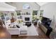 Well-lit living room with fireplace, large windows, and entertainment center at 4976 S Nelson St # A, Littleton, CO 80127