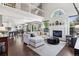 Open-concept living room with hardwood floors, a fireplace, and large windows letting in natural light at 4976 S Nelson St # A, Littleton, CO 80127
