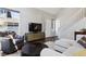 Cozy living room featuring hardwood floors, a plush sofa, and ample natural light from the large windows at 4976 S Nelson St # A, Littleton, CO 80127