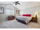 Vaulted main bedroom showcasing large windows, soft lighting, and a comfortable seating area for relaxation at 4976 S Nelson St # A, Littleton, CO 80127