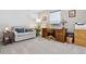 Well-lit home office with a wooden desk, a comfortable sofa, and neutral carpet at 4976 S Nelson St # A, Littleton, CO 80127