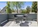 Outdoor patio featuring a table and two chairs, perfect for relaxing or enjoying a meal at 4976 S Nelson St # A, Littleton, CO 80127