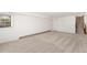 Spacious carpeted basement featuring a staircase, multiple closets and a window for natural light at 8270 S High Ct, Centennial, CO 80122