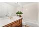The bathroom is well-lit and features a vanity, tub, and tiled shower at 8270 S High Ct, Centennial, CO 80122