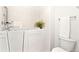 Accessible walk-in bathtub with tiled walls and a handheld shower fixture in the bright bathroom at 8270 S High Ct, Centennial, CO 80122