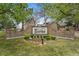 Community entrance features beautiful landscaping and an elegant sign at 8270 S High Ct, Centennial, CO 80122