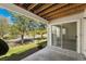 Covered patio with wooden ceiling overlooks green space and an easy access sliding glass door at 8270 S High Ct, Centennial, CO 80122
