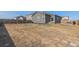 Large backyard with wooden fence and patio area at 1152 Payton Ave, Fort Lupton, CO 80621