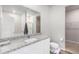 Bathroom with granite vanity, shower, and walk-in closet at 1152 Payton Ave, Fort Lupton, CO 80621