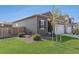 Gray exterior of home with a well manicured lawn, and mature trees at 1152 Payton Ave, Fort Lupton, CO 80621