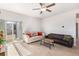 Bright living room with two sofas, coffee table, and sliding glass door at 1152 Payton Ave, Fort Lupton, CO 80621