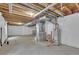 Unfinished basement with concrete floor, exposed pipes, and white walls at 3109 S Jebel Way, Aurora, CO 80013