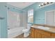 Colorful bathroom featuring a vanity, tub, and window at 3109 S Jebel Way, Aurora, CO 80013