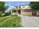Charming two-story home featuring a brick facade, a cozy front porch, and a spacious two-car garage at 3109 S Jebel Way, Aurora, CO 80013