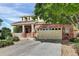Charming two-story home featuring a brick facade, a cozy front porch, and a spacious two-car garage at 3109 S Jebel Way, Aurora, CO 80013
