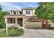 Charming two-story home featuring a brick facade, a cozy front porch, and a spacious two-car garage at 3109 S Jebel Way, Aurora, CO 80013