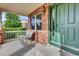 Inviting covered front porch with seating, brick facade, and stylish front door at 3109 S Jebel Way, Aurora, CO 80013