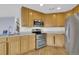 Modern kitchen with stainless steel appliances and wooden cabinetry at 3109 S Jebel Way, Aurora, CO 80013