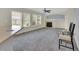 Bright open living room with fireplace, large windows, and neutral carpet at 3109 S Jebel Way, Aurora, CO 80013