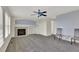 Open living room with fireplace, large windows, and neutral carpet at 3109 S Jebel Way, Aurora, CO 80013