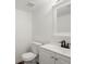 Clean bathroom with a white vanity, modern faucet, and white toilet at 1643 S Fairplay St, Aurora, CO 80012