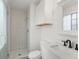 Modern bathroom with subway tile shower, white vanity, and sleek black hardware at 1643 S Fairplay St, Aurora, CO 80012