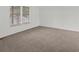 Comfortable bedroom with plush carpeting and a window bringing in natural light at 1643 S Fairplay St, Aurora, CO 80012