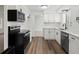 This kitchen has white cabinets, stainless appliances, vinyl floors, and subway tile backsplash at 1643 S Fairplay St, Aurora, CO 80012