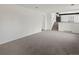 Bright living room featuring neutral carpet and white walls leading up to the staircase at 1643 S Fairplay St, Aurora, CO 80012