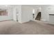 Bright living room featuring neutral carpeting, staircase, and lots of natural light at 1643 S Fairplay St, Aurora, CO 80012