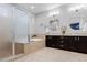 Bright bathroom with double vanity, soaking tub, and glass shower at 1815 Avery Way, Castle Rock, CO 80109