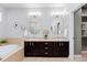 Bathroom featuring double sinks, modern lighting, and tile flooring at 1815 Avery Way, Castle Rock, CO 80109