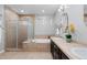 Well-lit bathroom featuring a soaking tub, glass shower, double vanity, and tile flooring at 1815 Avery Way, Castle Rock, CO 80109