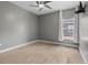Neutral bedroom offers natural light, ceiling fan, and hardwood floors at 1815 Avery Way, Castle Rock, CO 80109