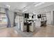 Dining room features a modern table, light wood floors, and a view of the updated kitchen at 1815 Avery Way, Castle Rock, CO 80109